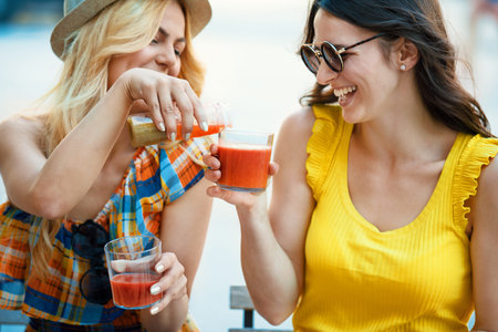 Young and attractive woman having fresh drink in cafe.の写真素材