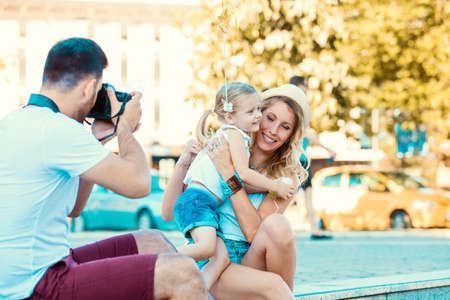 Young happy family is enjoying traveling and shooting photos.の写真素材