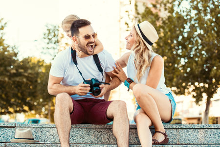 Young happy family is enjoying traveling and shooting photos.