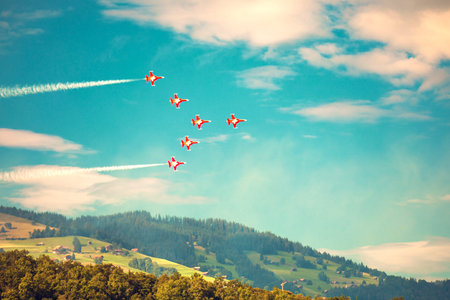 A team of fighter aircraft performs team work ability in Swiss Alps.