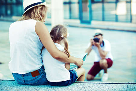 Young happy family is enjoying traveling and shooting photos.の写真素材