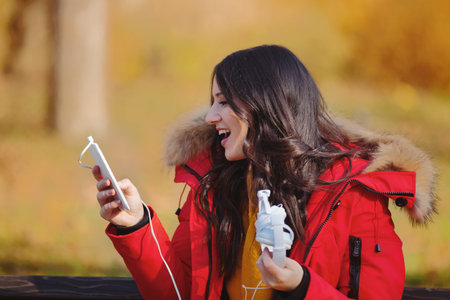 Beautiful young woman enjoying autumn in the park.