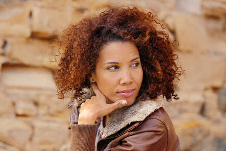 Beautiful woman enjoying autumn day in the park.の写真素材