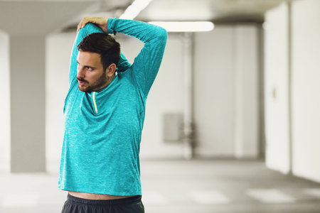 Young athlete man is exercising in garage.