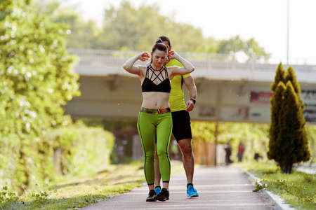Early morning workout. Happy couple running. Living healthy lilfestyle.の写真素材
