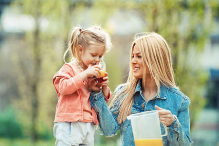 Mother and daughter enjoying picnic in the parkの写真素材