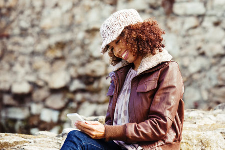Beautiful woman enjoying autumn day in the park.の写真素材