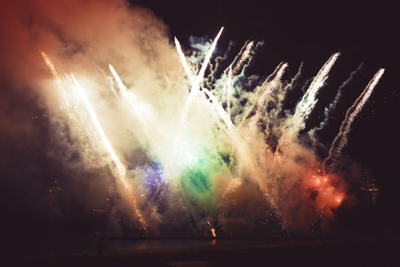 Colorful fireworks of various colors over night sky .
