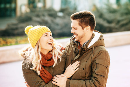 Young smiling couple is enjoying city in the morning.