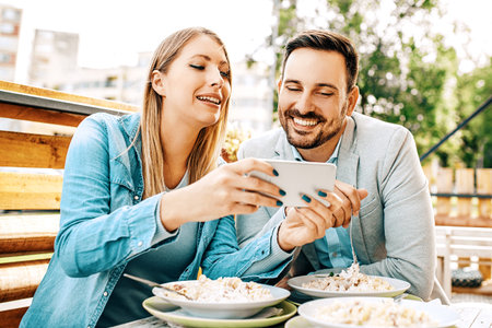 Young couple enjoying restaurant and eating pasta.