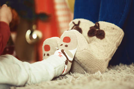 Young mother and her four years old daughter celebrating Christmas.の写真素材