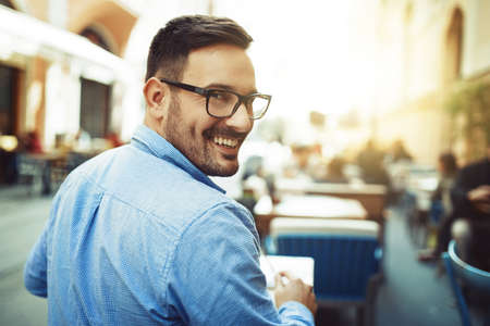 Businessman having coffee and doing his work in cafe.の写真素材