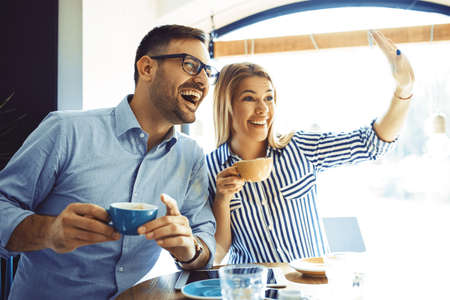 Young couple in love enjoying time spending with each other in cafÃ©. の写真素材