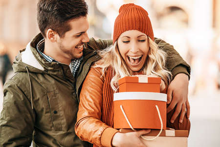 Young smiling couple enjoying Christmas shopping.の写真素材