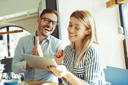Young couple in love enjoying time spending with each other in coffee shop.の写真素材