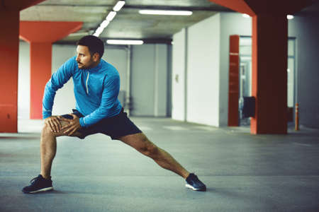 Young athlete man is exercising in garage.の写真素材