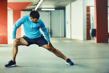 Young athlete man is exercising in garage.の写真素材