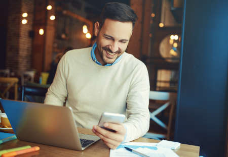 Businessman enjoying coffee and doing his freelance job.の写真素材