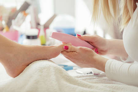 Woman feet receiving pedicure. Close up concept. の写真素材