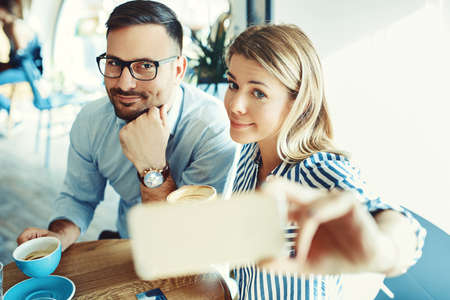 Young couple in love enjoying time spending with each other in cafÃ©. の写真素材
