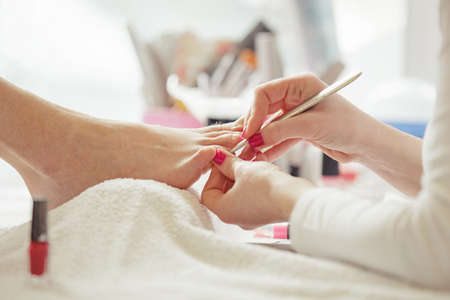 Woman feet receiving pedicure. Close up concept. の写真素材