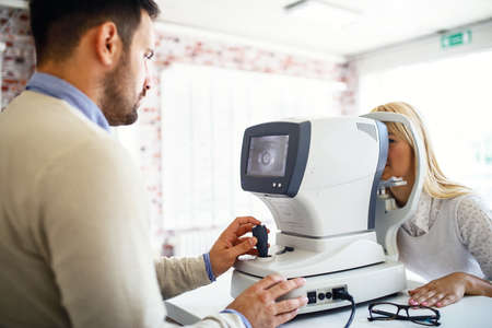 Woman in optics store having ophthalmologist examination.の写真素材