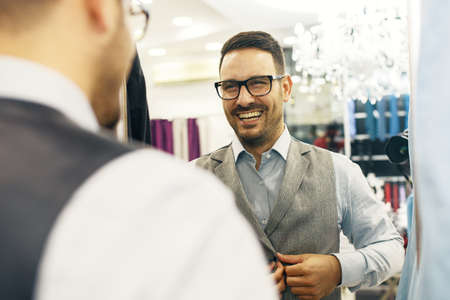 Portrait of handsome young man buying clothes in the store.の写真素材