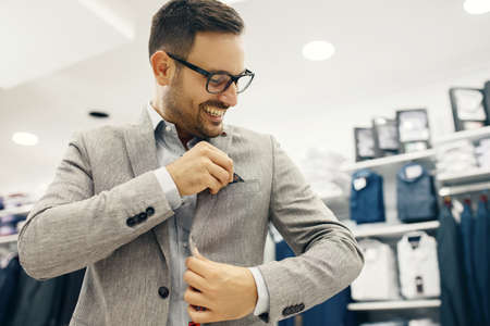 Portrait of handsome young man buying clothes in the store.の写真素材