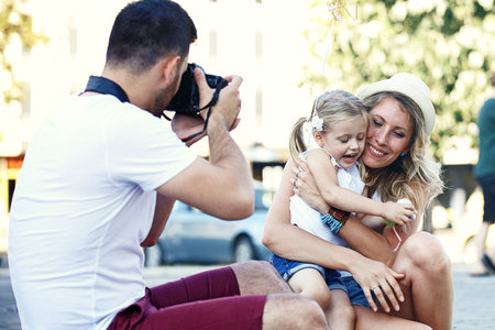 Young happy family is enjoying traveling and shooting photos.の写真素材
