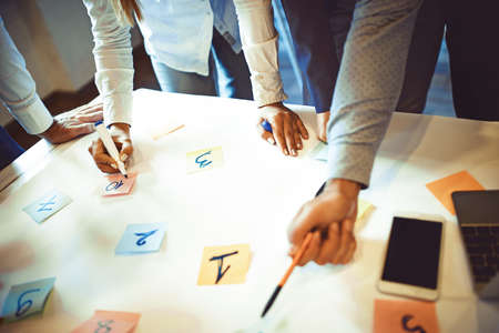 Creative business team working on project. Creative director is showing chart to the workers.の写真素材