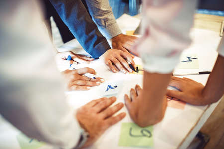 Creative business team working on project. Creative director is showing chart to the workers.の写真素材
