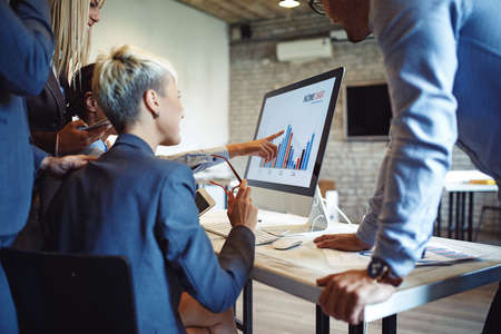 Creative business team working on project. Creative director is showing chart to the workers.の写真素材
