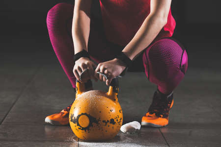 Young strong woman is training with kettlebell.の写真素材