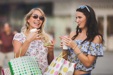Beautiful young women enjoying shopping and having fun.の写真素材