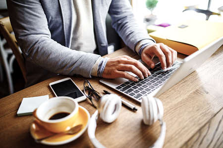 Businessman enjoying coffee shop and doing his freelance job.の写真素材