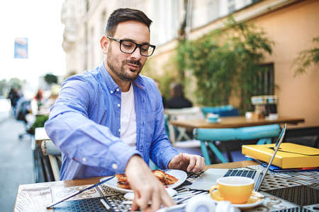 Businessman enjoying coffee shop and doing his freelance job.の写真素材