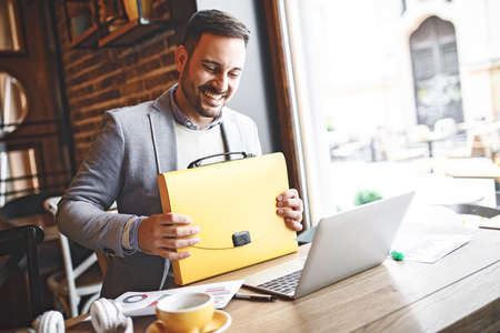 Businessman enjoying coffee shop and doing his freelance job.の写真素材