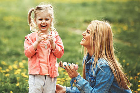 Mother and daughter enjoying picnic in the park.の写真素材