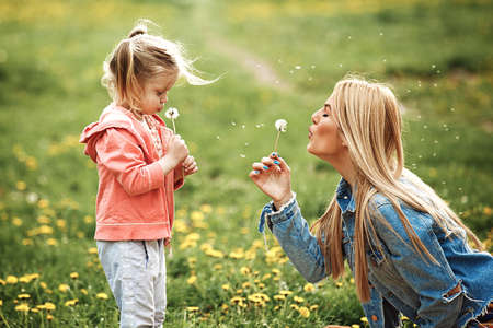 Mother and daughter enjoying picnic in the park.の写真素材
