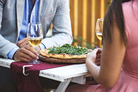 Love couple is enjoying pizza in restaurant.の写真素材