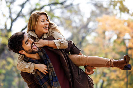 Young smiling couple enjoying in the park.の写真素材