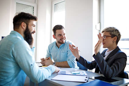 Creative business team working on project. Creative director is showing chart to the workers.の写真素材