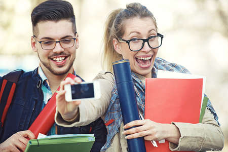 Student couple happy because of succesful graduation.の写真素材