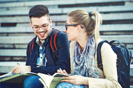 Student couple happy because of succesful graduation.の写真素材