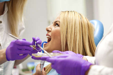 Female dentist and young woman patient in dentist office.の写真素材