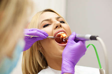 Female dentist and young woman patient in dentist office.の写真素材
