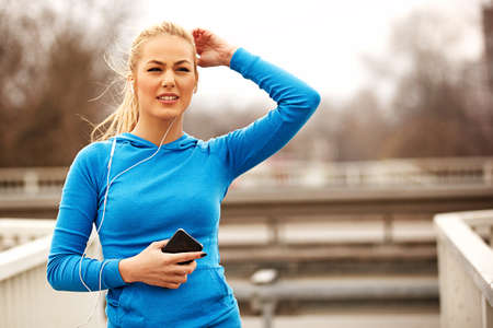 Young blonde woman is relaxing after exercise.の写真素材
