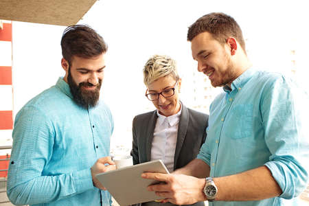 Creative business team working on project. Creative director is showing chart to the workers.の写真素材