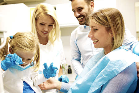 Happy family is having fun in dental office.の写真素材