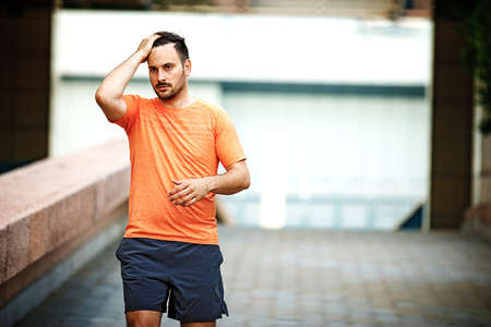 Young athlete man is jogging in the city.の写真素材